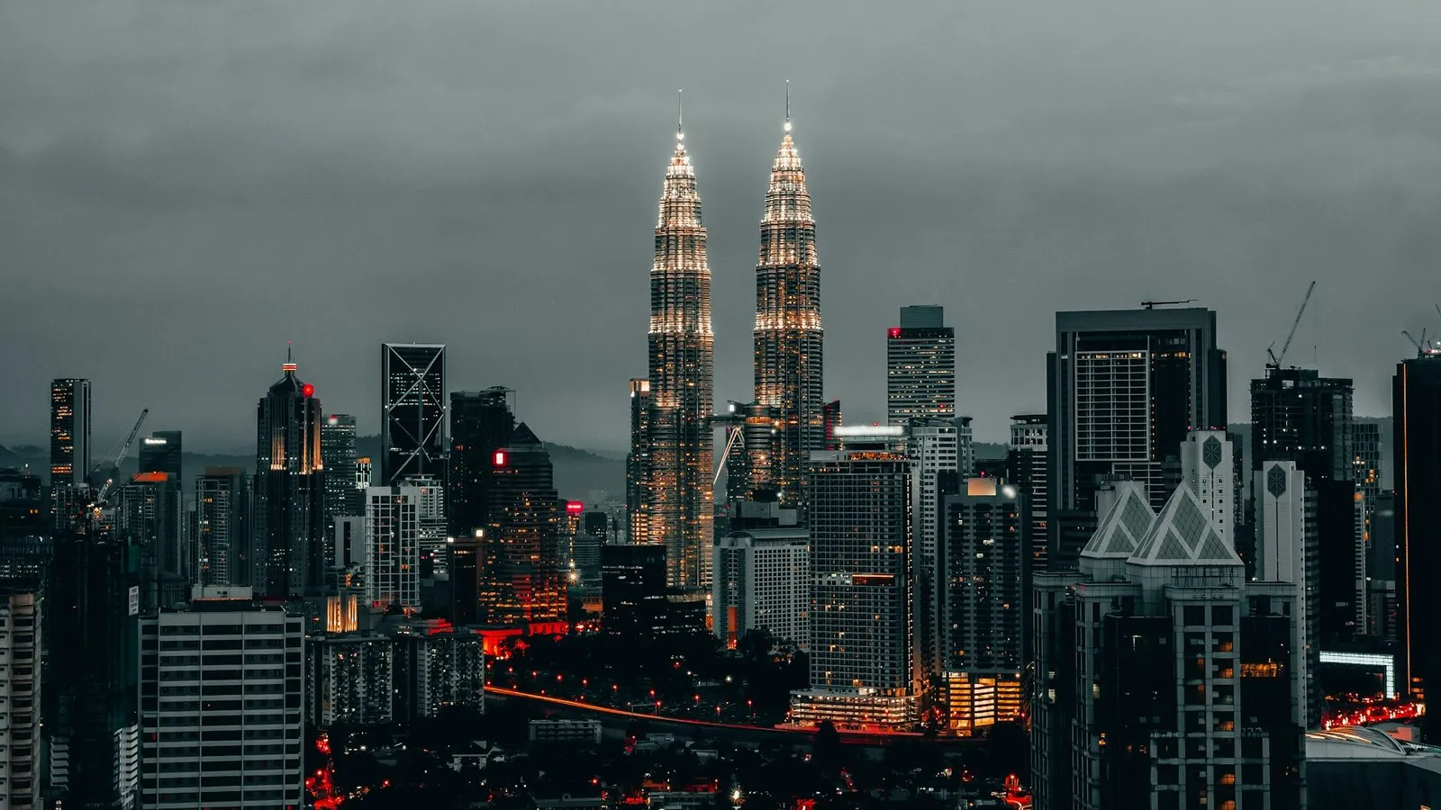 Kuala Lumpur city skyline with the Petronas Twin Towers lit up at dusk, the first stop of a Malaysia incentive trip